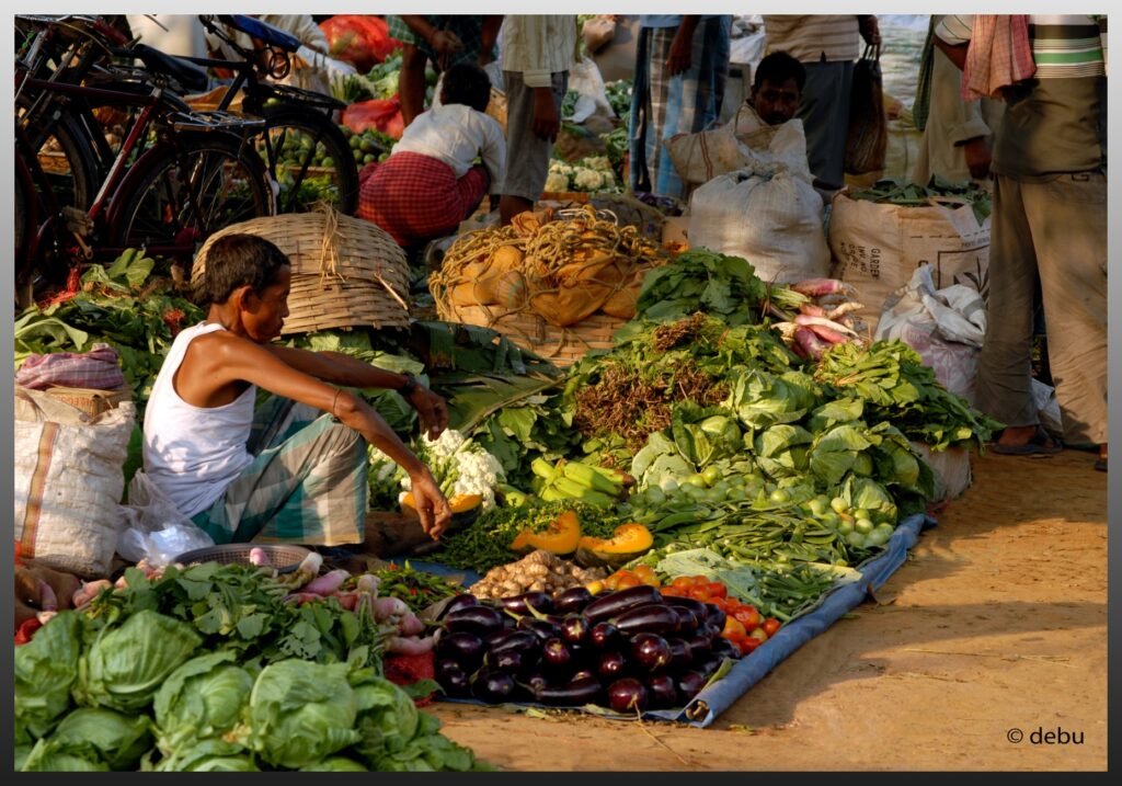 Man selling varieties vegetable.