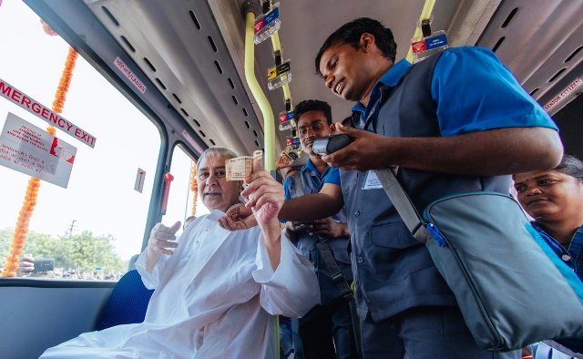 Chief Minister Naveen Patnaik booking a seat on mo bus and talking to the the bus conductor