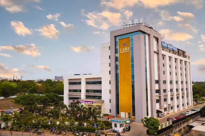 Care hospital Bhubaneswar campus surrounded by greenery under a vibrant sky